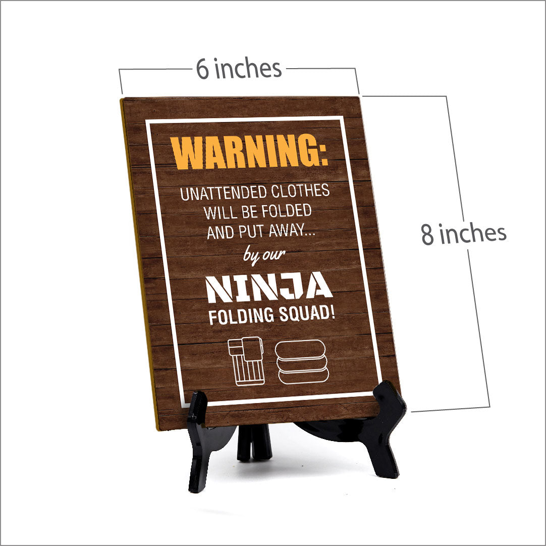 Signs ByLITA Warning: Unattended clothes will be folded and put away... by our ninja folding squad! Table Sign with Acrylic Stand (6x8“)