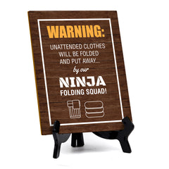 Signs ByLITA Warning: Unattended clothes will be folded and put away... by our ninja folding squad! Table Sign with Acrylic Stand (6x8“)